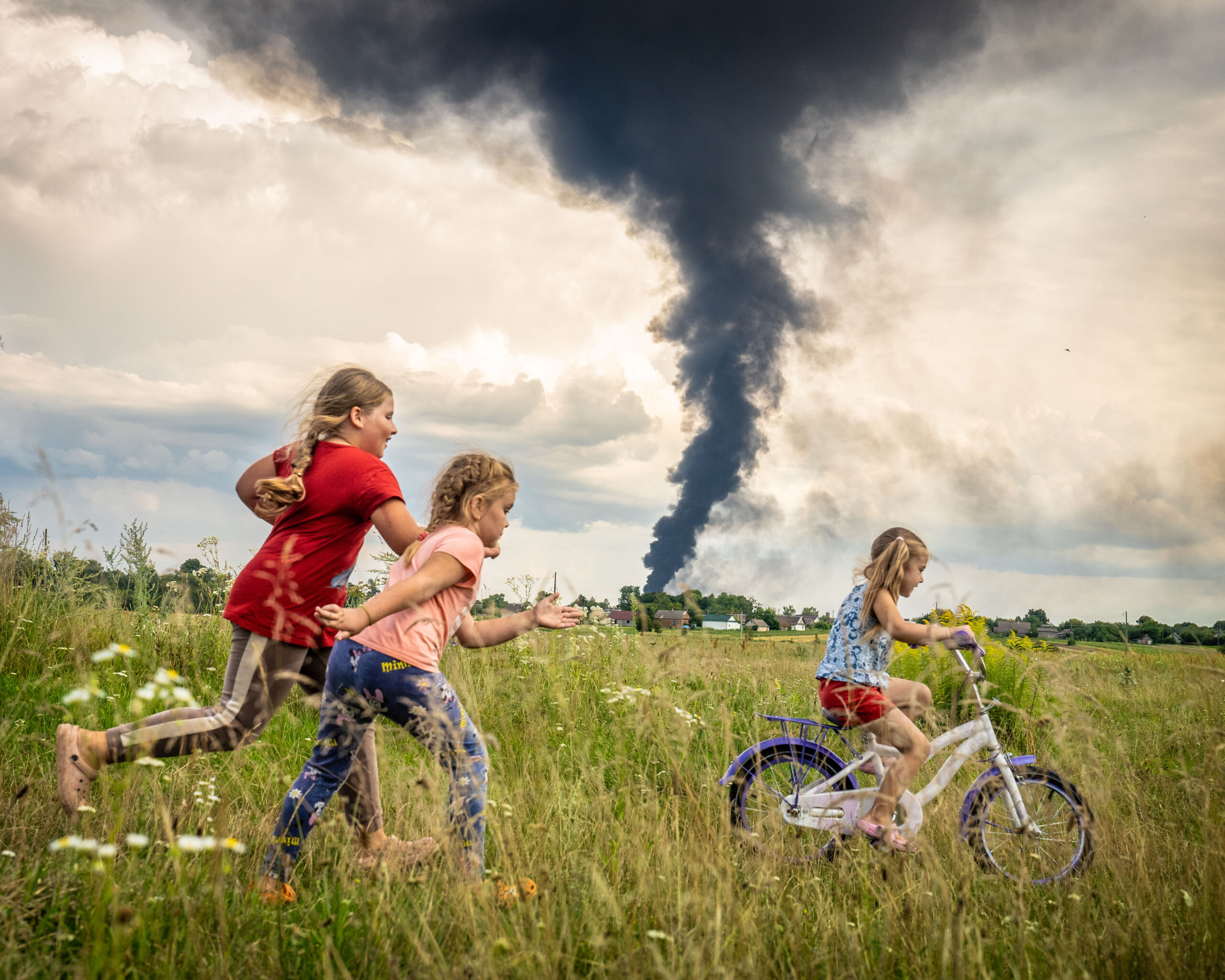 Kids learning how to ride a bicycle in the fields of Ukraine. orange desert on film